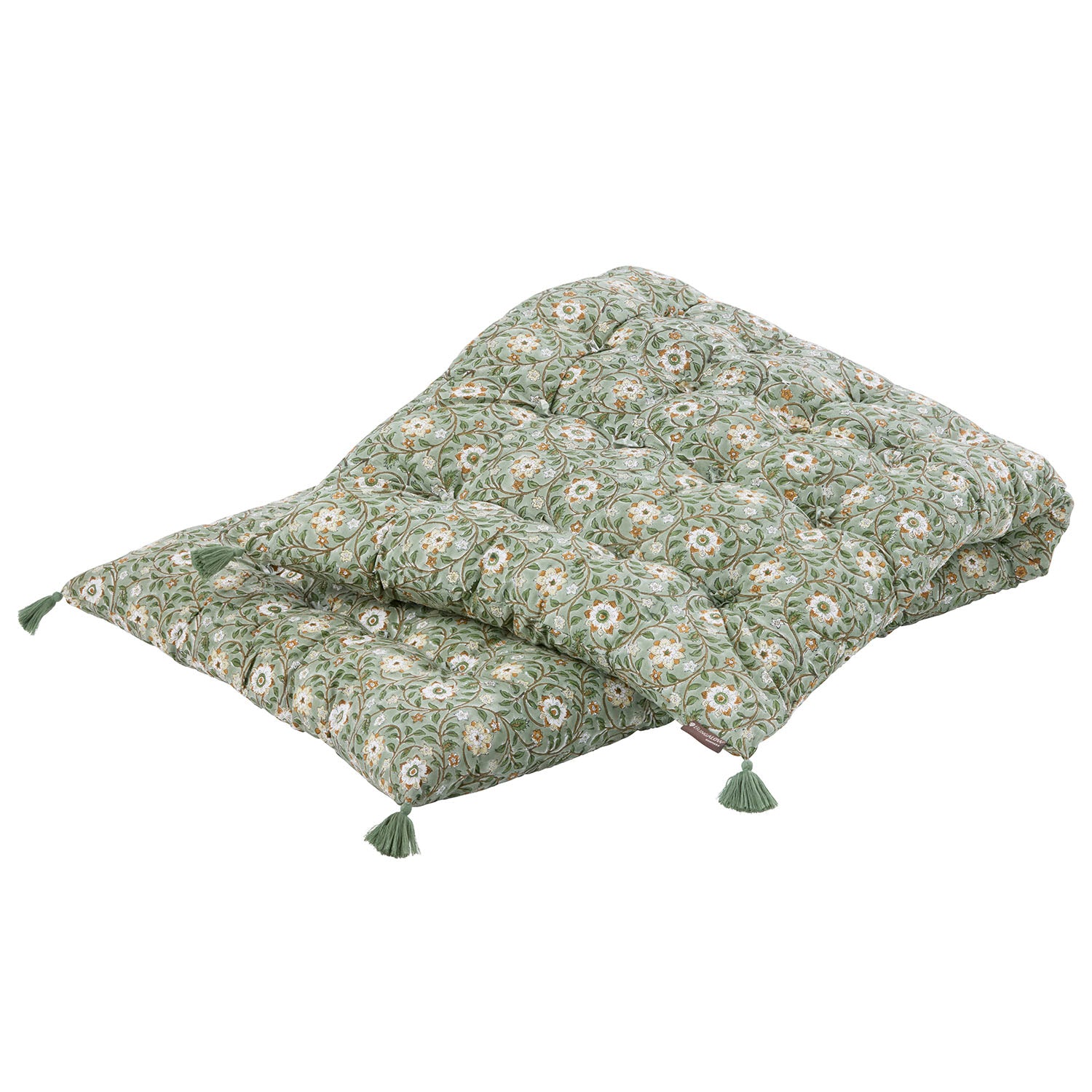 Green floral-patterned cushions with tassels on a white background