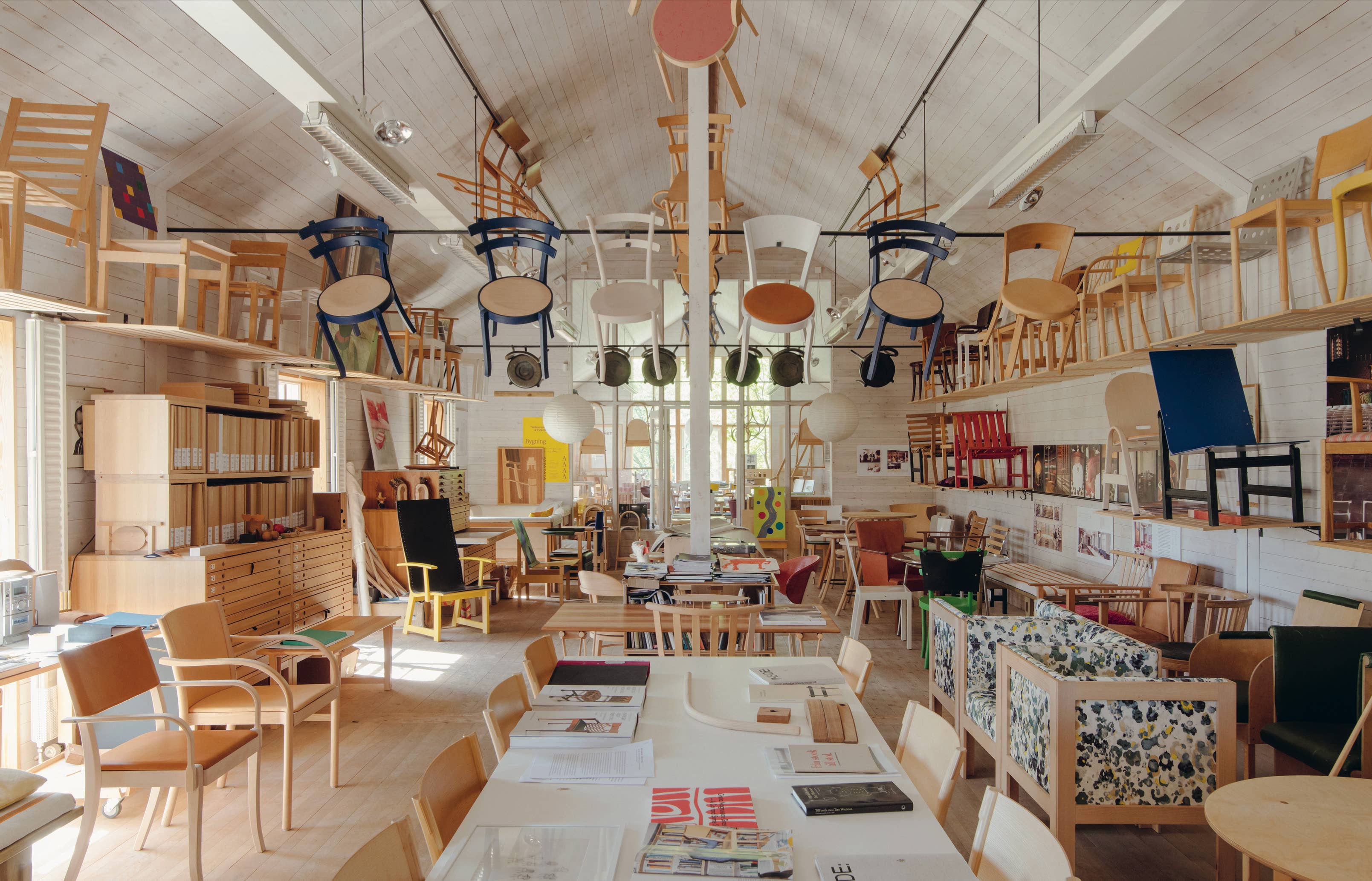 Interior of a furniture store with various chairs and tables on display.